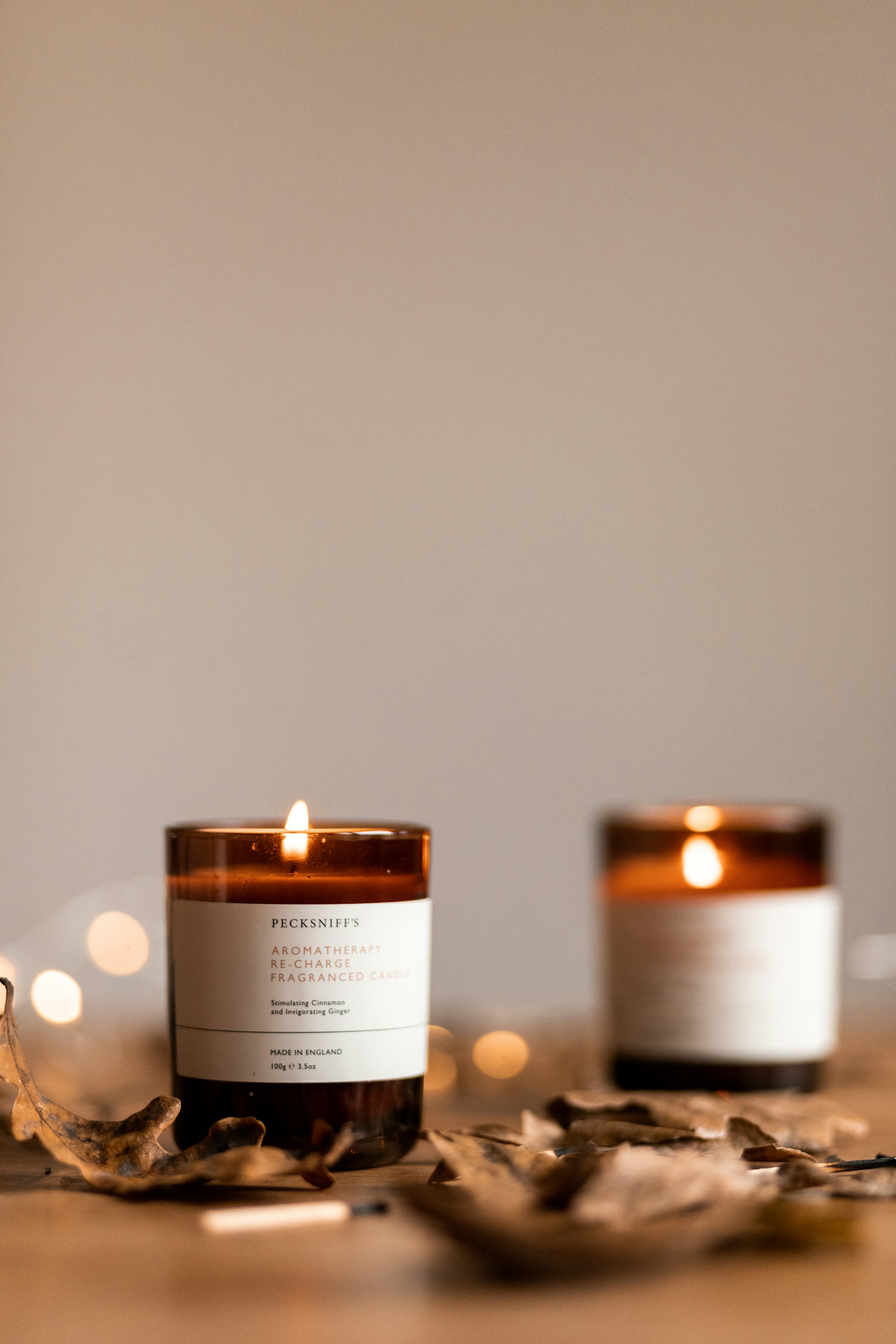 Lifestyle photograph of hand-poured candles in a warm, minimalist setting